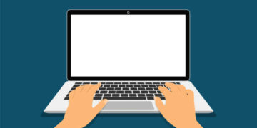 Hands on a laptop keyboard. The concept of working at a laptop top view.